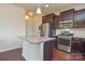 Well-lit kitchen with a granite island, stainless steel appliances, and hardwood floors at 173 Glastonbury Dr, Mooresville, NC 28115