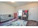 Cozy room with a comfy couch, a bright window, and a practical storage area for everyday necessities at 173 Glastonbury Dr, Mooresville, NC 28115