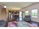 Open-concept living space flows into kitchen, featuring dark wood floors and plenty of natural light at 173 Glastonbury Dr, Mooresville, NC 28115