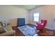 Bright room features stylish gray sofa, red chair, and a window for natural light at 173 Glastonbury Dr, Mooresville, NC 28115