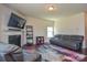 Comfortable living room features a fireplace, large TV, and a plush gray sectional sofa at 173 Glastonbury Dr, Mooresville, NC 28115