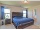 Comfortable main bedroom with wood-paneled headboard and two windows allowing for natural light at 173 Glastonbury Dr, Mooresville, NC 28115