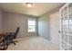 A home office with gray walls, a window, a carpeted floor, and a black office chair at 173 Glastonbury Dr, Mooresville, NC 28115