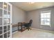 A home office with gray walls, carpeted floors, a built-in desk, and a comfortable black office chair at 173 Glastonbury Dr, Mooresville, NC 28115
