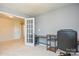 Office with gray walls, carpeted floors, an adjustable desk, and a comfortable black office chair at 173 Glastonbury Dr, Mooresville, NC 28115