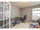 Home office with neutral walls, featuring a desk setup and natural light filtering through the window at 173 Glastonbury Dr, Mooresville, NC 28115