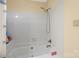 Bathroom tub and shower combination with white tiles and handheld shower head at 1919 Windlock Dr, Charlotte, NC 28270