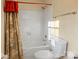 Clean bathroom with a white tiled shower and tub combination, complemented by modern fixtures and warm lighting at 1919 Windlock Dr, Charlotte, NC 28270