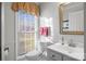 Powder room with a window, vanity, and toilet; a tidy and bright small space at 1919 Windlock Dr, Charlotte, NC 28270