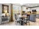 Dining area next to kitchen with gray painted cabinets and a view to the backyard at 1919 Windlock Dr, Charlotte, NC 28270
