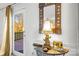 Stylish entryway featuring a decorative mirror, elephant lamp, and table with a view to the back deck at 1919 Windlock Dr, Charlotte, NC 28270