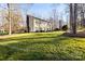 Expansive green lawn and mature trees surround this two-story home with classic architecture at 1919 Windlock Dr, Charlotte, NC 28270