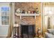 Close-up of a brick fireplace with decorative mantel and ornate details at 1919 Windlock Dr, Charlotte, NC 28270