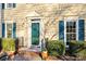 Charming home exterior with a welcoming teal front door, classic shutters and manicured landscaping at 1919 Windlock Dr, Charlotte, NC 28270