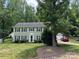Charming two-story home with green siding, dark shutters, and well-manicured lawn at 1919 Windlock Dr, Charlotte, NC 28270
