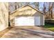 Detached garage with a clean white door and ample parking space, next to a meticulously kept lawn at 1919 Windlock Dr, Charlotte, NC 28270