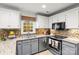 Well-equipped kitchen featuring gray cabinets, stainless steel appliances, and a stylish mosaic backsplash at 1919 Windlock Dr, Charlotte, NC 28270