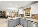 Charming kitchen featuring granite countertops, mosaic backsplash, gray cabinets, and stainless steel sink at 1919 Windlock Dr, Charlotte, NC 28270