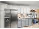 Kitchen showcasing stainless steel refrigerator, gray cabinets, granite countertops, and backsplash details at 1919 Windlock Dr, Charlotte, NC 28270