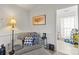 Cozy sitting area with comfortable chair, side table, and a glimpse into an organized, bright closet at 1919 Windlock Dr, Charlotte, NC 28270