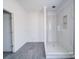 Bright bathroom with a modern glass-enclosed shower featuring elegant marble-style tile at 236 Mark Ryan Ln, Dallas, NC 28034