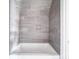 Modern bathroom featuring stylish gray tiling in the shower and a sleek white tub at 236 Mark Ryan Ln, Dallas, NC 28034