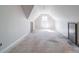 Unfinished bonus room featuring vaulted ceiling with a large window providing abundant natural light at 236 Mark Ryan Ln, Dallas, NC 28034
