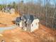 Newly constructed two-story home featuring neutral brick, an attached garage and a mulit-gable roof at 236 Mark Ryan Ln, Dallas, NC 28034