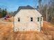 Rear elevation of a new home construction highlighting the brick exterior and window placement at 236 Mark Ryan Ln, Dallas, NC 28034