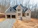 Newly constructed two-story home featuring a two-car garage and neutral brick exterior at 236 Mark Ryan Ln, Dallas, NC 28034