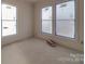 Bright, unfinished room showing three large windows with blue painter's tape at 236 Mark Ryan Ln, Dallas, NC 28034