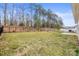 Large grassy backyard enclosed with a black iron fence at 2479 Seagull Dr, Denver, NC 28037