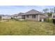 Fenced backyard with view of home and small patio at 2479 Seagull Dr, Denver, NC 28037