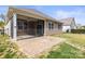 Back of house showing screened porch with adjacent stone patio at 2479 Seagull Dr, Denver, NC 28037