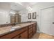 A bathroom featuring a dual sink vanity with granite countertops and framed mirrors at 2479 Seagull Dr, Denver, NC 28037