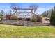 Stone sign for Covington at Lake Norman, surrounded by lush greenery and landscaping at 2479 Seagull Dr, Denver, NC 28037