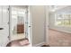 Open hallway view to bedroom and bathroom featuring wood flooring, offering functionality and style at 2479 Seagull Dr, Denver, NC 28037