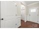 Bright hallway showcasing hardwood floors, white trim, and a welcoming entrance at 2479 Seagull Dr, Denver, NC 28037