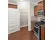 Kitchen featuring stainless steel appliances, pantry, granite countertops, and wood cabinets at 2479 Seagull Dr, Denver, NC 28037