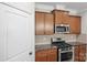 Kitchen featuring stainless steel appliances, granite countertops, and wooden cabinets at 2479 Seagull Dr, Denver, NC 28037