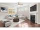 Cozy living room with fireplace and a large window, offers a relaxing space for the whole Gathering at 2479 Seagull Dr, Denver, NC 28037
