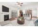Stylish living room featuring a fireplace, modern decor, and an open view to the kitchen at 2479 Seagull Dr, Denver, NC 28037