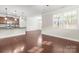 Open-concept living space with hardwood floors, kitchen bar, and ample natural light at 2479 Seagull Dr, Denver, NC 28037