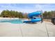 Community pool featuring a slide, beautiful blue water and mature trees in the background at 2479 Seagull Dr, Denver, NC 28037