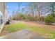 Spacious backyard featuring a concrete patio, grassy area, white fence, and mature trees, perfect for outdoor enjoyment at 2679 Southern Trace Dr, Waxhaw, NC 28173