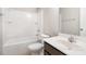 A clean bathroom showcasing a shower-tub combo, toilet, and sink with storage underneath at 2679 Southern Trace Dr, Waxhaw, NC 28173
