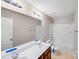 Well-lit bathroom with a double vanity, shower-tub combo, and ceramic tile flooring at 2679 Southern Trace Dr, Waxhaw, NC 28173