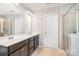 Bright bathroom featuring double sinks, neutral-toned tile flooring, and framed mirrors at 2679 Southern Trace Dr, Waxhaw, NC 28173