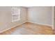 Empty bedroom with wood-look floors and a large window that brings in natural light at 2679 Southern Trace Dr, Waxhaw, NC 28173
