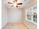 Cozy bedroom with carpet flooring, ceiling fan, and a window with privacy blinds at 2679 Southern Trace Dr, Waxhaw, NC 28173